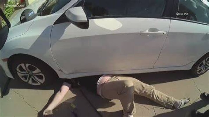 The man was pinned to the ground by the man in a military uniform