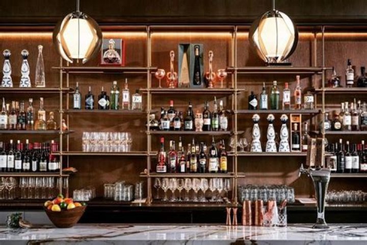 The massive bar features shelves of liquor