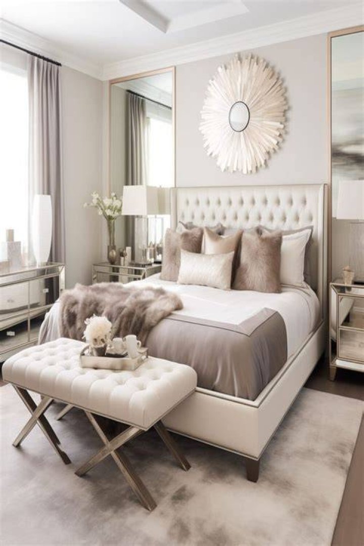 The master bedroom features plush cream furnishings and a TV area