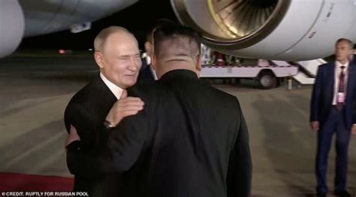 The pair hugged as Kim stood by awkwardly, smiling and looking down