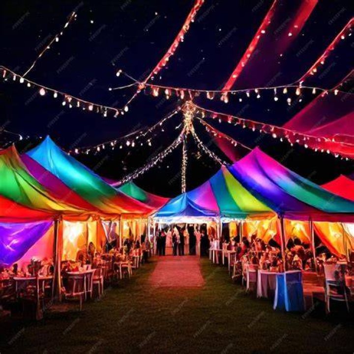 The rainbow-themed tent along with a "restroom" sign and cake knife