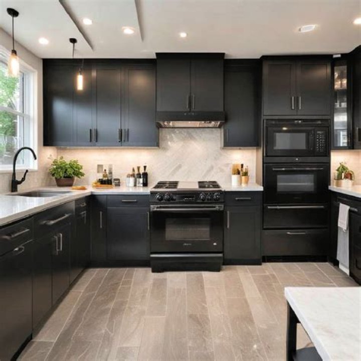 The remodeled kitchen boasts black cabinets and a cooper kitchen island