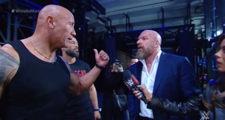The Rock then exploded backstage at WWE boss Triple H, right, in an X-rated rant
