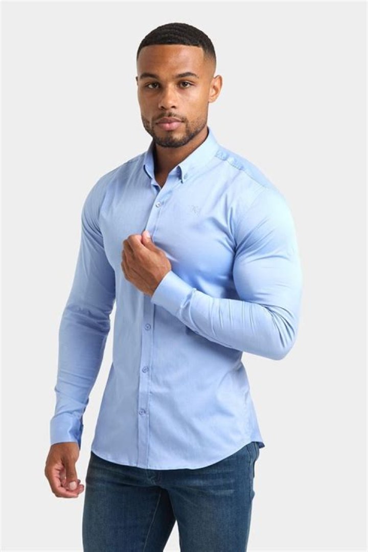 The shirt features a blue trim around the collar and sides
