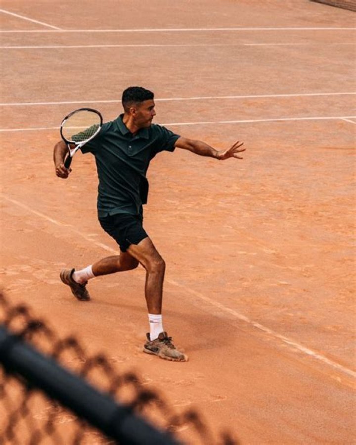 The tennis champ posed at Wimbledon to celebrate the new deal