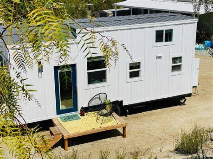 The tiny home even boasts a patio and garden that overlooks the forest