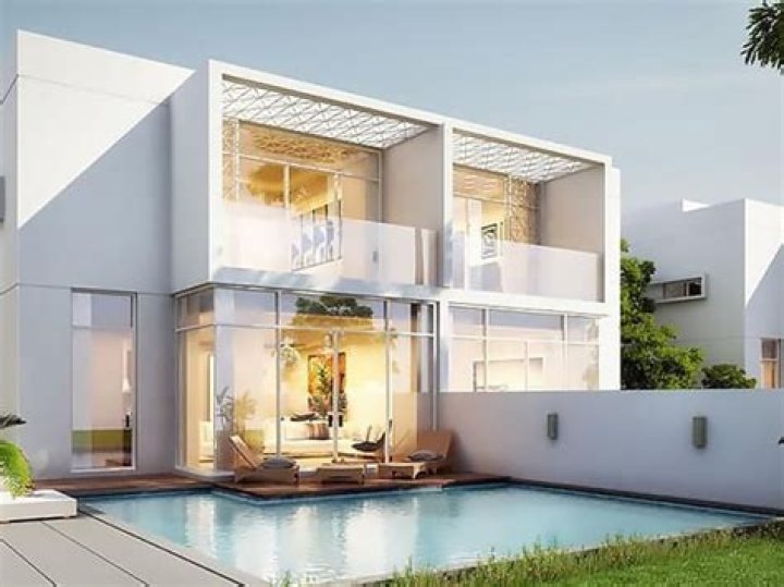 The two homes are shielded from the public with huge leafy trees