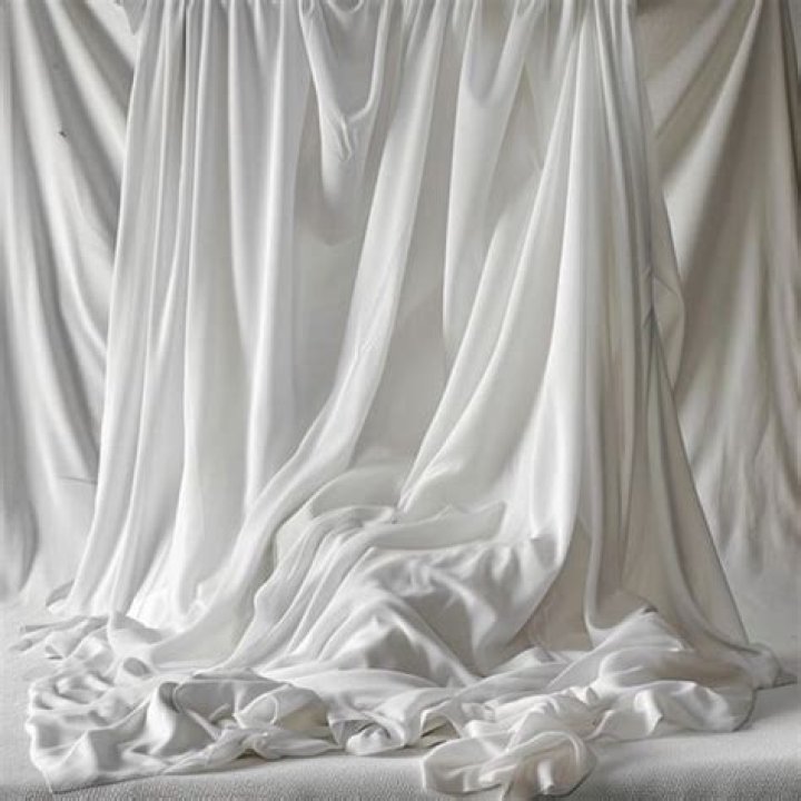 The white fabric draped all the way to the balcony floor, ensuring privacy