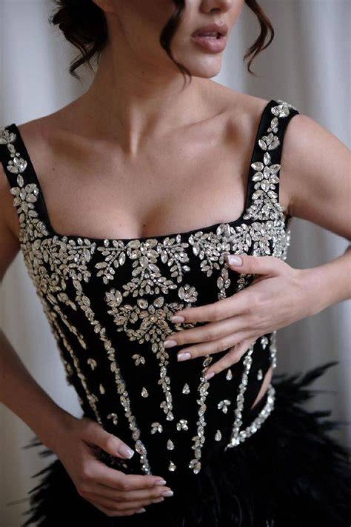 This burlesque-like two-piece is still too big for her boobs