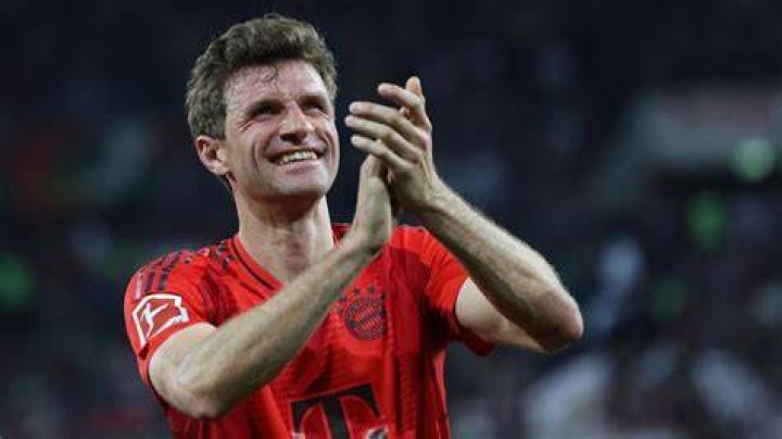 Thomas Muller appears to be apologetic as Musiala grips his leg