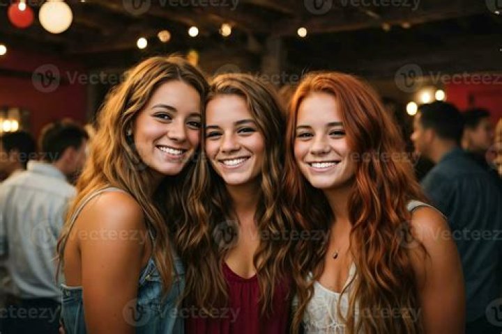 Three party-girls line up their bucket loads of booze