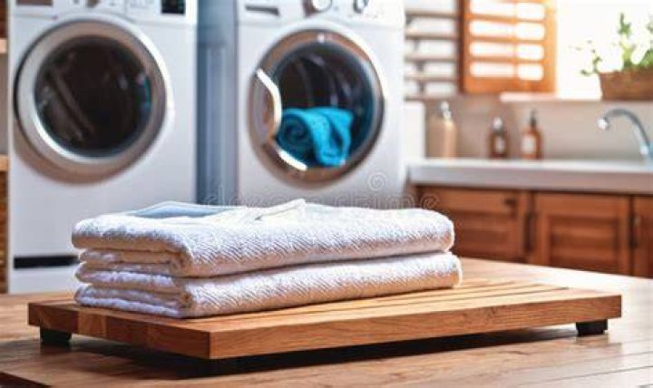 Tub with freshly washed laundry and socks hanging on the radiator