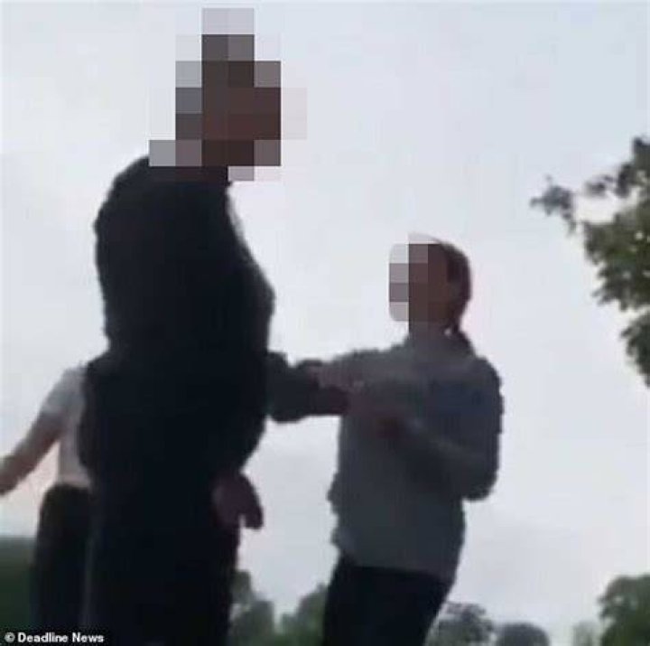 Two schoolgirls viciously kicked and punched the defenseless teen before dragging her by her hair