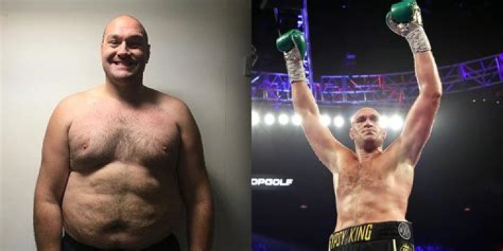 Tyson Fury holds a weight in his mouth using a small towel