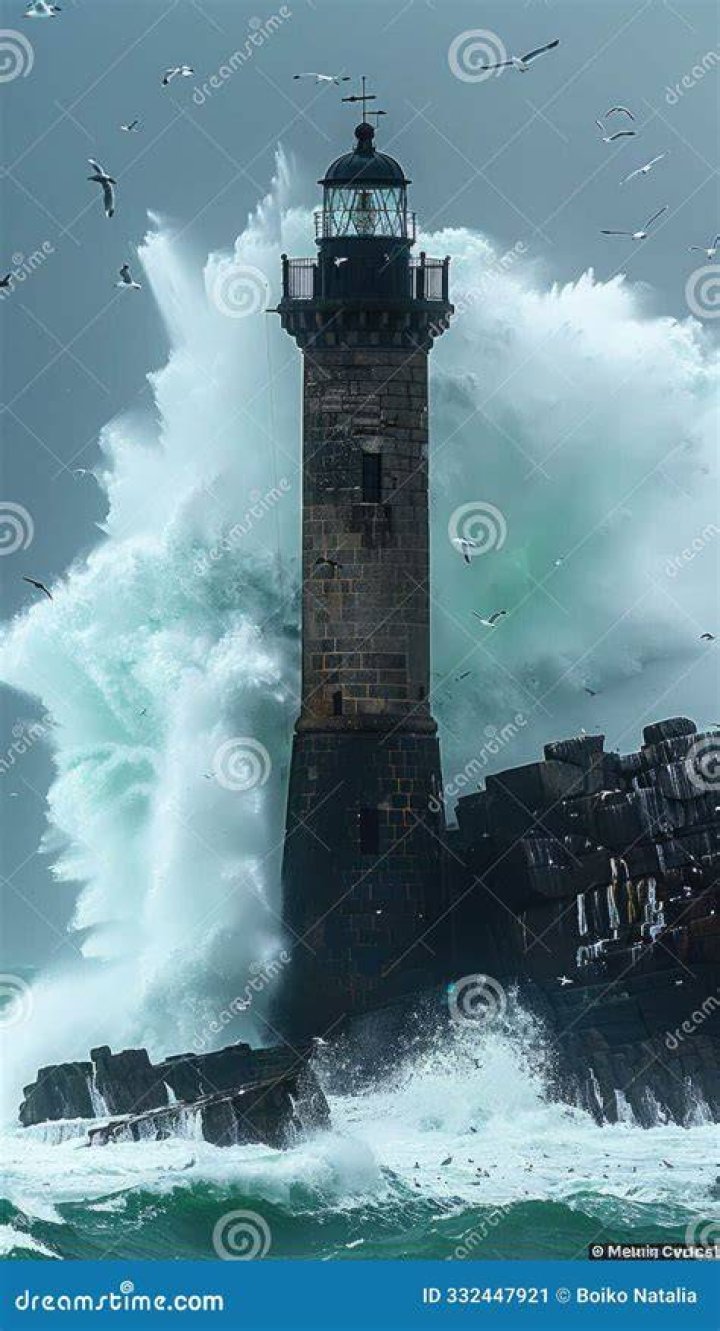 Waves crash around a lighthouse in Folkestone, Kent this morning